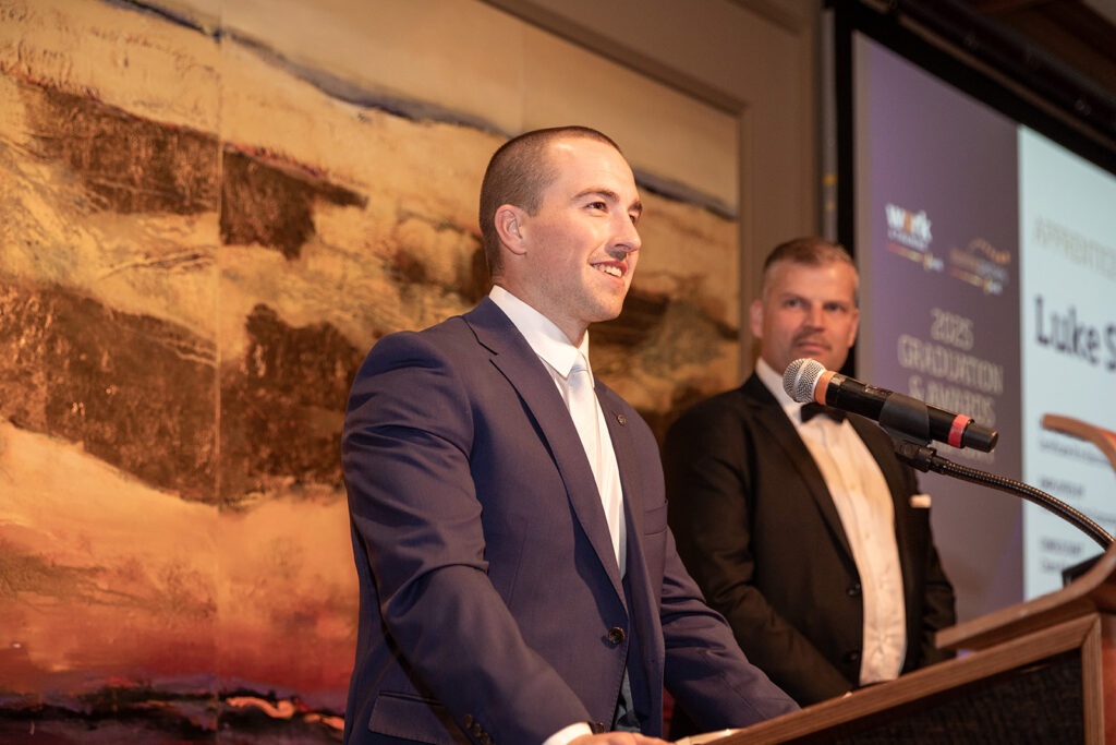 Luke speaking from a podium at an awards evening