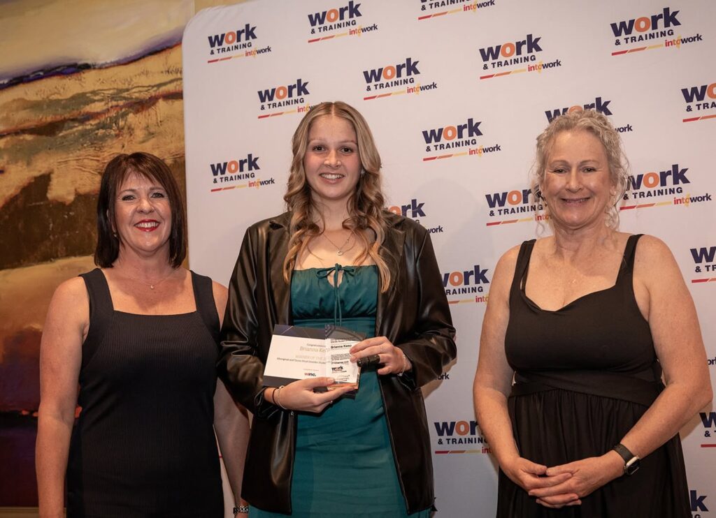 Brianna and Work & Training staff holding award certificate